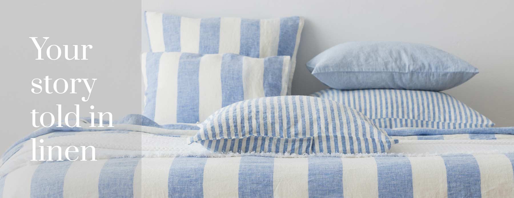 Your story told in linen – blue and white striped linen bedding and pillows.