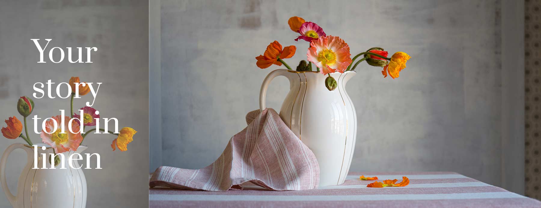 Your story told in linen – pink striped linen tablecloth and napkin with colourful poppies in a white jug.