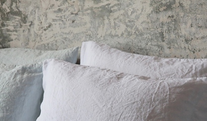 White linen pillows on a guest bed