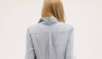 Woman wearing a striped linen button-up shirt