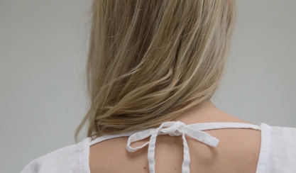 Back detail of a white linen dress with tie straps