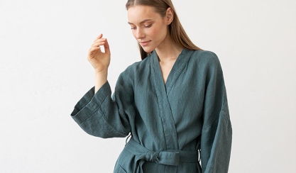 Linen bath robes and towels arranged for a summer holiday