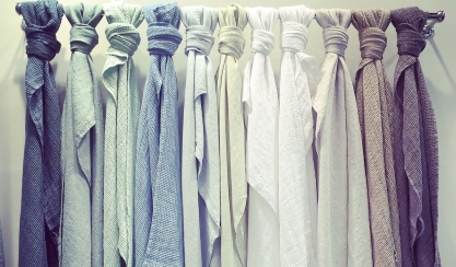 Neutral linen textiles displayed on a rail