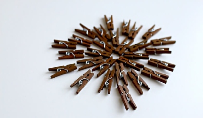 Wooden clothes pegs arranged in a circle