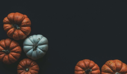 Orange and white pumpkins on a dark background