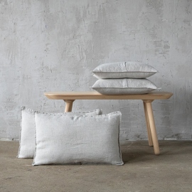 Oatmeal linen cushions on a wooden bench