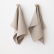 Natural Lara linen towels hanging on a wall