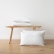 Optical-white Terra linen cushions beside a wooden bench