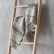 Close view of forest green and natural striped linen tea towels on a ladder